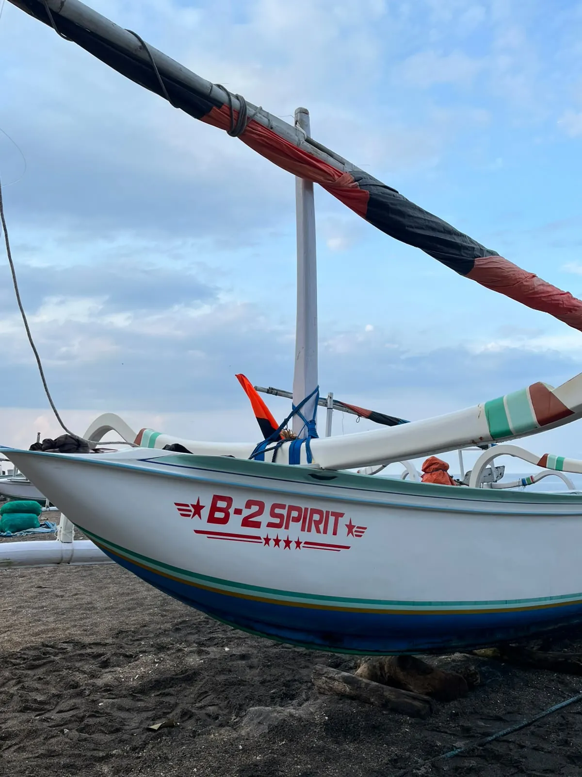 Traditional Balinese boat on Lipah beach, ready for an Amed snorkeling trip